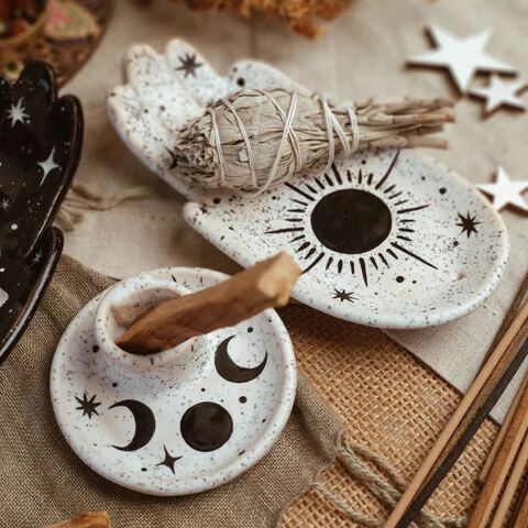 A white palm with the painting of the Sun