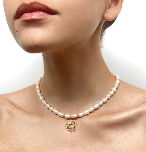 A pearl necklace with a golden heart