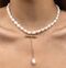 A pearl necklace with a pendant in the middle