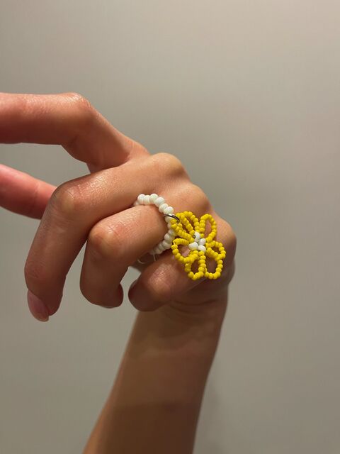 A white ring with a yellow flower