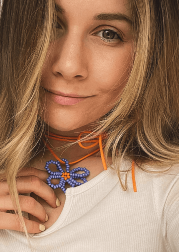 A blue flower on an orange string