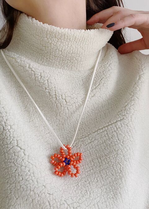 Orange flower on a white string