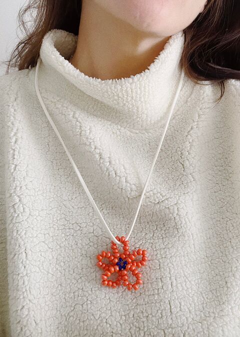 Orange flower on a white string