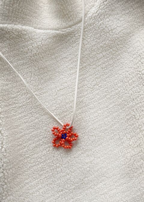 Orange flower on a white string