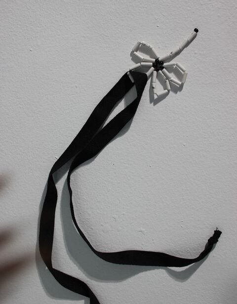 White flower on a black ribbon