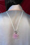 Necklace with a pink flower and a carabiner