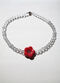 Daisy choker with a red flower.