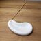 White drop stone with a hole for incense sticks