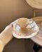 Set of cup and saucer with red branches