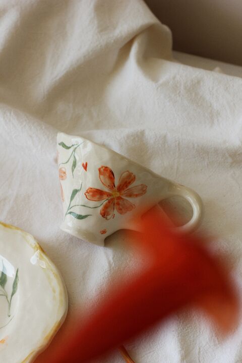 Cup with orange flowers