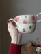 Cup with red and green Christmas trees