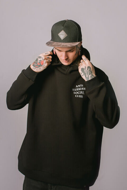 Black oversized ARSC hoodie with a white logo on the back