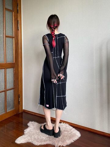 Black dress with white seams and slits at the legs