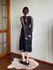 Black dress with white seams and slits at the legs