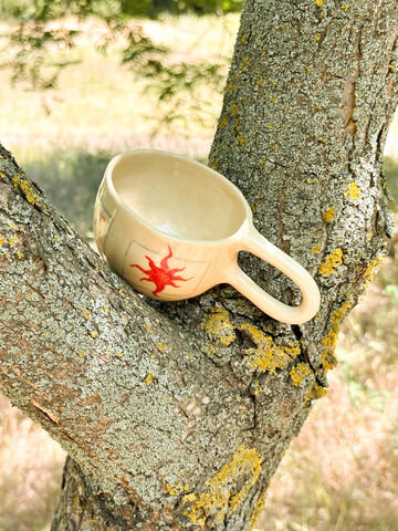 A cup with a Sun