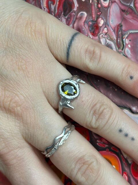 Ring with olive cubic zirconia