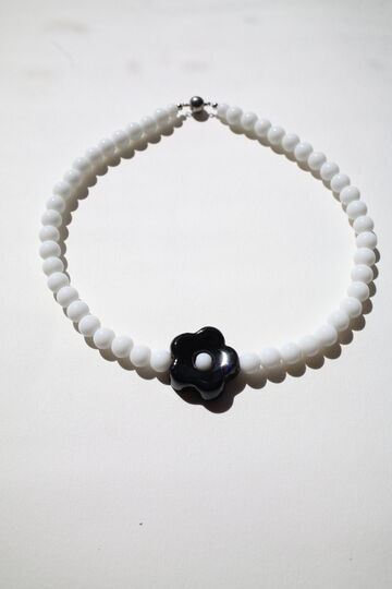 Choker Daisy with a black flower on a white base